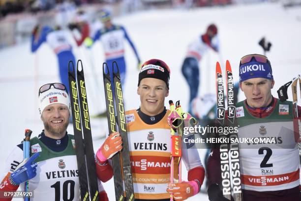 2nd placed Martin Johnsrud Sundby of Norway, his compatriot and winner Johannes Hoesflot Klaebo and 3rd placed Alexander Bolshunov of Russia pose...