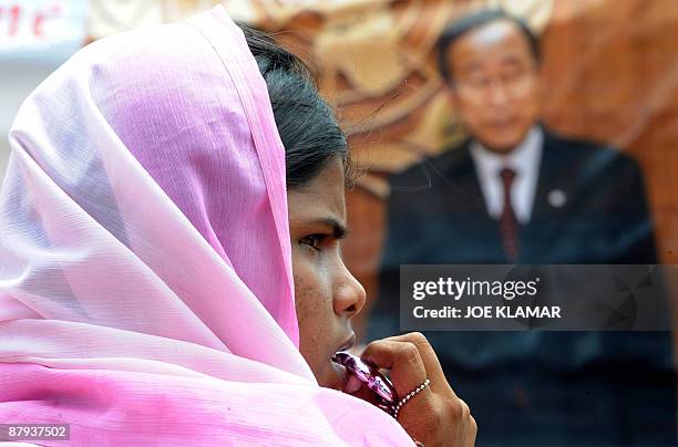 An internally displaced Sri Lankan woman waits during a visit by United Nations Secretary-General Ban Ki-moon at Menik Farm refugee camp in...