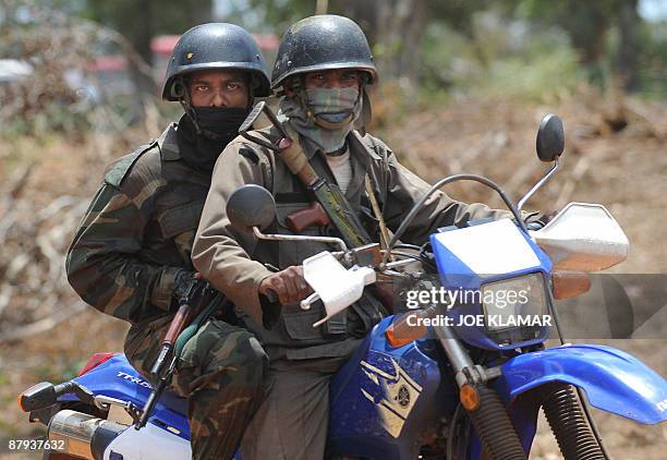 Sri Lankan soldiers on motorcycle escort the convoy of United Nations Secretary-General Ban Ki-moon during his visit to Menik Farm refugee camp in...