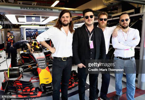 Mumford and Sons pose for a photo outside the Red Bull Racing garage before the Abu Dhabi Formula One Grand Prix at Yas Marina Circuit on November...