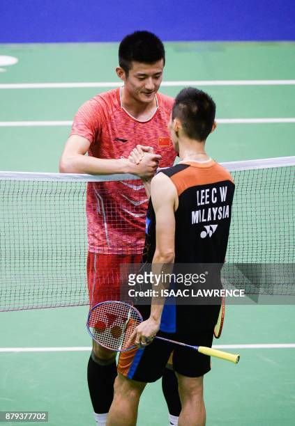 China's Chen Long congratulates Malaysia's Lee Chong Wei on his win in the men's singles final at the Hong Kong Open badminton tournament in Hong...
