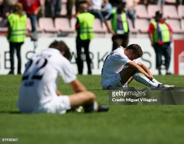 Christian Adler and Marcus Steegmann of Aalen look dejected after losing the 3. Liga match between SpVgg Unterhaching and VfR Aalen at the...