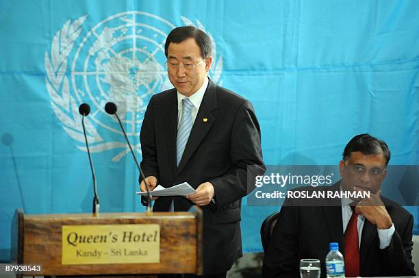 United Nations Secretary General Ban Ki-moon walks to the podium to deliver his speech while Sri Lankan Minister of Foreign Affairs Rohitha...
