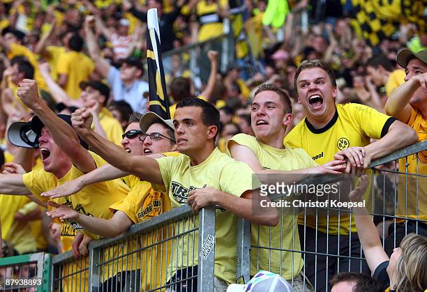 The fans of Dortmund celebrate their team during the Bundesliga match between Borussia Moenchengladbach and Borussia Dortmund at the Borussia Park on...