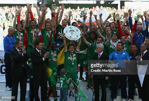 Josue of Wolfsburg lifts the German Championship trophy after the Bundesliga match between VfL Wolfsburg and Werder Bremen at the Volkswagen Arena on...