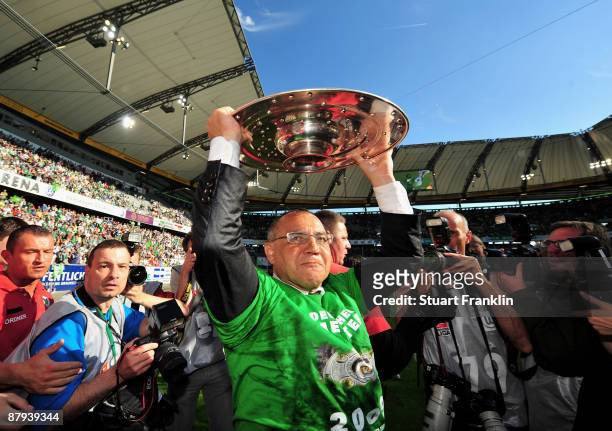 Felix Magath, head coach of Wolfsburg celebrates lifting the German Championship trophy after the Bundesliga match between VfL Wolfsburg and Werder...