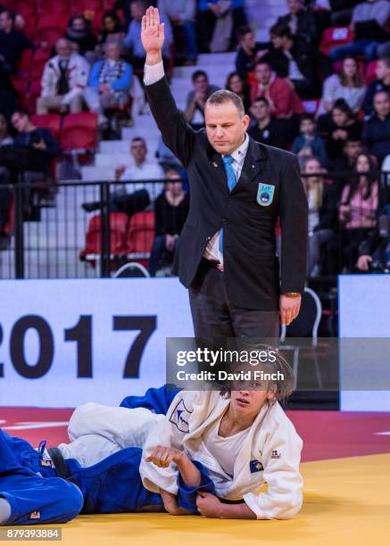 The referee signals 'ippon' after the eventual gold medallist, Nora Gjakova of Kosovo held Mina Libeer Belgium for 20 seconds to win their u57kg...