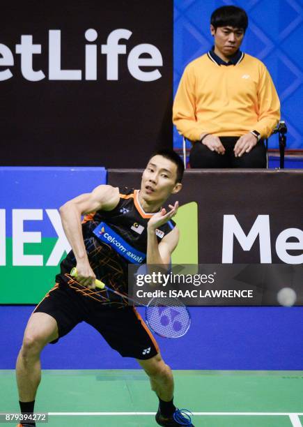 Malaysia's Lee Chong Wei hits a shot against China's Chen Long during the men's singles final at the Hong Kong Open badminton tournament in Hong Kong...