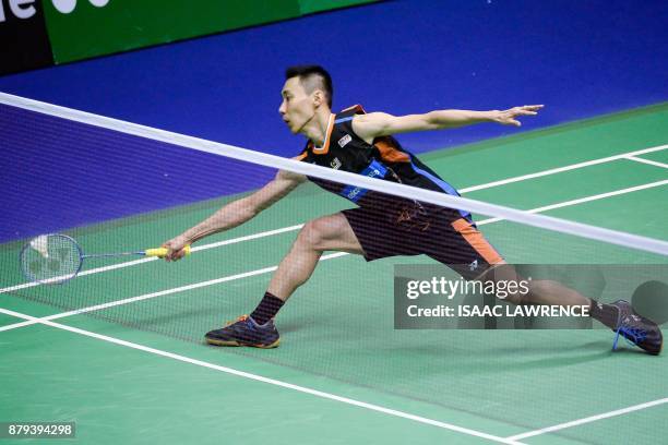 Malaysia's Lee Chong Wei hits a shot against China's Chen Long during the men's singles final at the Hong Kong Open badminton tournament in Hong Kong...