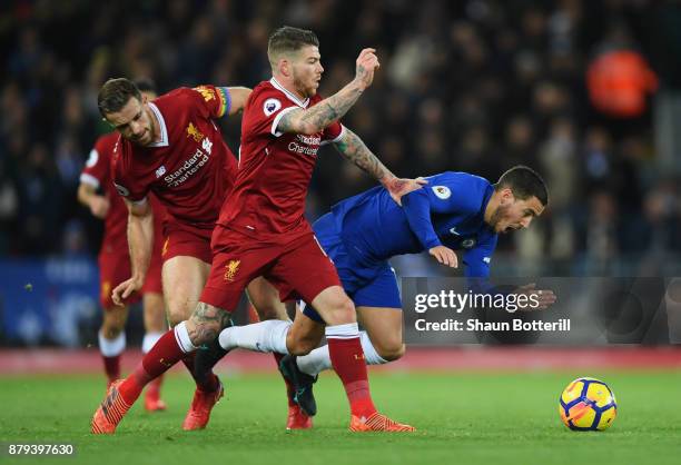 Eden Hazard of Chelsea is challenged by Jordan Henderson and Alberto Moreno of Liverpool during the Premier League match between Liverpool and...