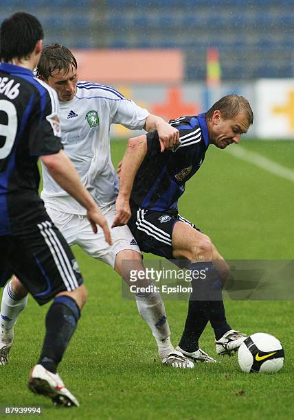Aleksei Ivanov of FC Saturn Moscow Oblast battles for the ball with Aleksander Kharitonov of FC Tom', Tomsk during the Russian Football League...