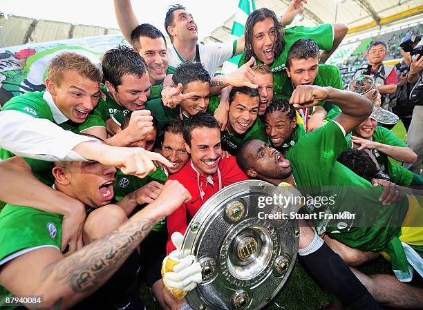 Players of Wolfsburg celebrate the German championship with the trophy after their Bundesliga match against SV Werder Bremen at Volkswagen Arena on...