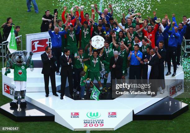 Team Wolfsburg celebrates the German championship with the trophy after their Bundesliga match against SV Werder Bremen at Volkswagen Arena on May...