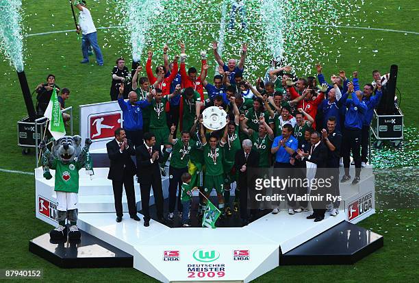 Team VfL Wolfsburg celebrates the German championship with the trophy after their Bundesliga match against SV Werder Bremen at Volkswagen Arena on...