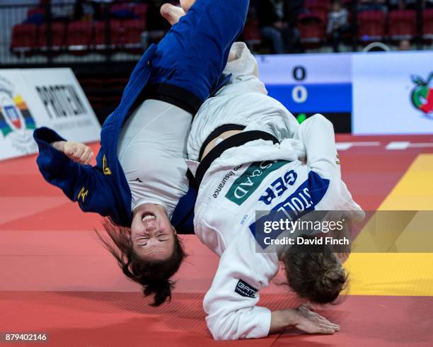 Theresa Stoll of Germany throws her sister, Amelie Stoll for a wazari to win their u57kg quarter-final contest as she progressed to the final during...