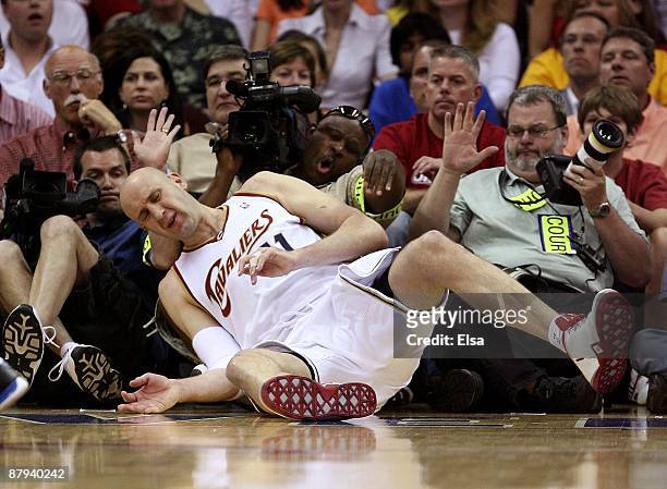 Zydrunas Ilgauskas of the Cleveland Cavaliers falls into photographers against the Orlando Magic in Game Two of the Eastern Conference Finals during...