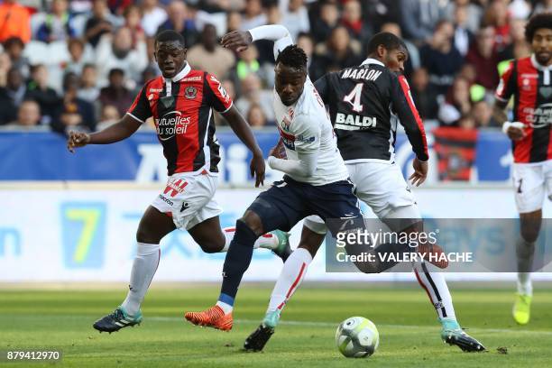 Lyon's French forward Maxwel Cornet fights for the ball with Nice's defender Marlon Santos during the French L1 football match Nice vs Lyon at The...