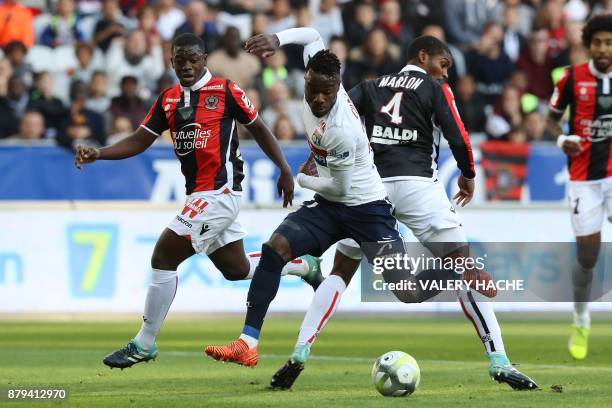 Lyon's French forward Maxwel Cornet fights for the ball with Nice's defender Marlon Santos during the French L1 football match Nice vs Lyon at The...