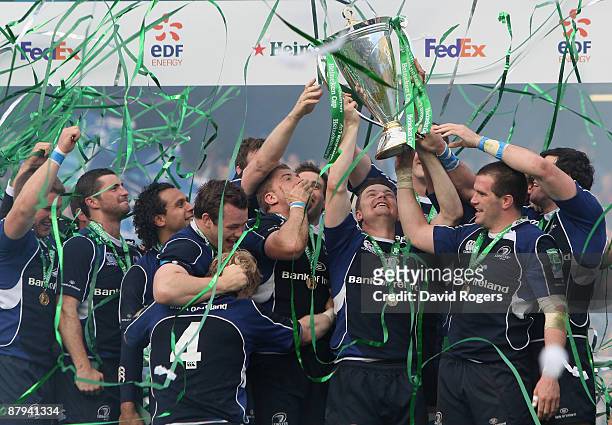 Brian O'Driscoll of Leinster lifts the trophy as his team mates celebrate following their victory at the end of the Heineken Cup Final match between...
