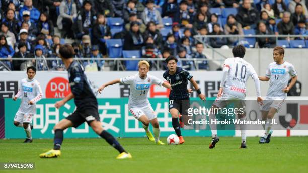 Akito Fukumori of Consadole Sapporo and Akito Takagi of Gamba Osaka compete for the ball during the J.League J1 match between Gamba Osaka and...
