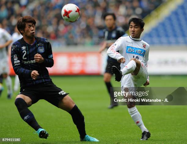 Chanathip Songkrasin of Consadole Sappporo and Genta Miura of Gamba Osaka compete for the ball during the J.League J1 match between Gamba Osaka and...