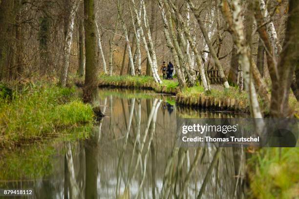 Luebbenau, Germany Two people are walking along a canal of the Spree in the Spreewald Biosphere Reserve on November 20, 2017 in Luebbenau, Germany.