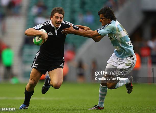 Kurt Baker of New Zealand holds off Martin Bostos Moyano of Argentina during day one of the IRB London Sevens at Twickenham Stadium on May 23, 2009...