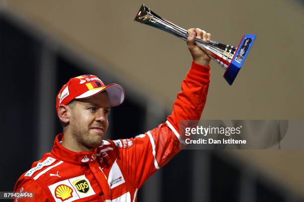 Third place finisher Sebastian Vettel of Germany and Ferrari celebrates on the podium during the Abu Dhabi Formula One Grand Prix at Yas Marina...
