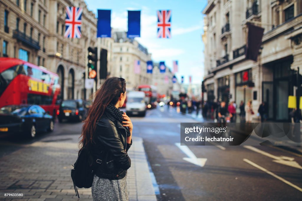 Young woman crossing the street in Central London