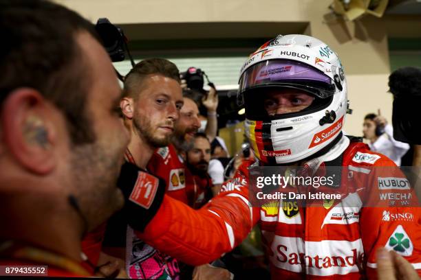Third place finisher Sebastian Vettel of Germany and Ferrari celebrates with his team in parc ferme during the Abu Dhabi Formula One Grand Prix at...