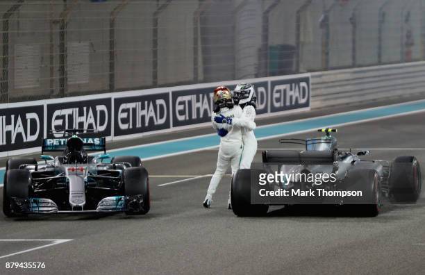 Second place finisher Lewis Hamilton of Great Britain and Mercedes GP celebrates on track with race winner Valtteri Bottas of Finland and Mercedes GP...