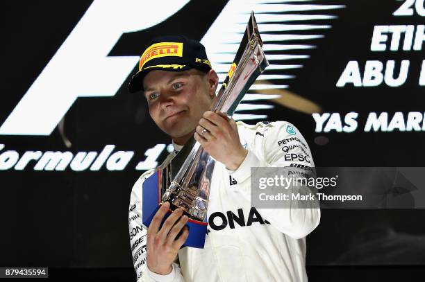 Race winner Valtteri Bottas of Finland and Mercedes GP celebrates on the podium during the Abu Dhabi Formula One Grand Prix at Yas Marina Circuit on...