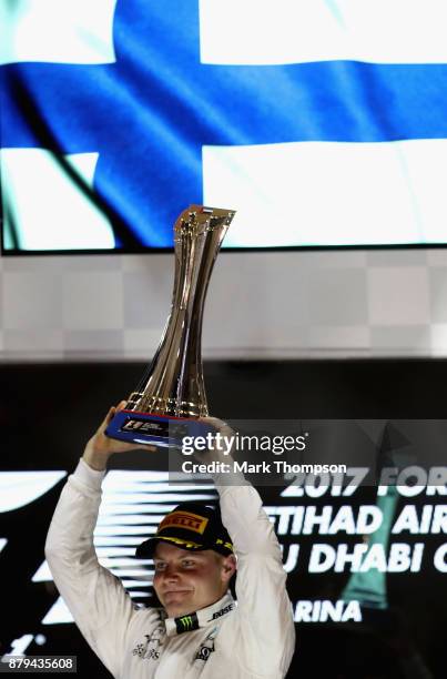 Race winner Valtteri Bottas of Finland and Mercedes GP celebrates on the podium during the Abu Dhabi Formula One Grand Prix at Yas Marina Circuit on...