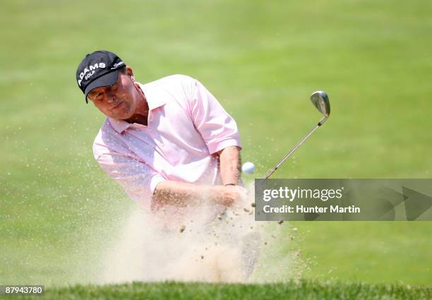 Scott Hoch hits his third shot on the 4th hole during the third round of the 70th Senior PGA Championship at Canterbury Golf Club on May 23, 2009 in...