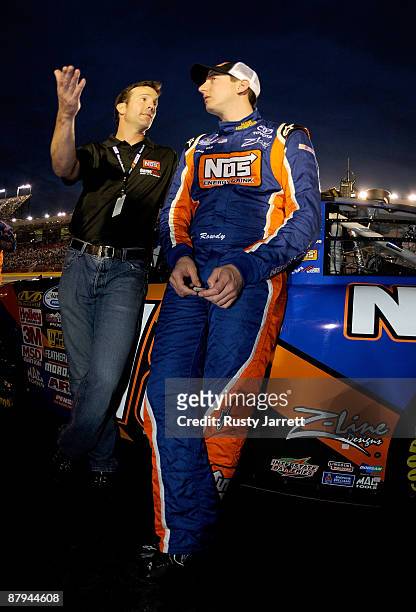 Car owner J.D. Gibbs talks with Kyle Busch, driver of the NOS Energy Drink Toyota, on the grid prior to the NASCAR Nationwide Series CARQUEST Auto...