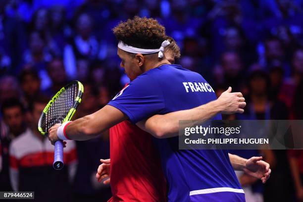 France's Jo-Wilfried Tsonga hugs Belgium's David Goffin after losing their singles rubber 4 of the Davis Cup World Group final tennis match between...