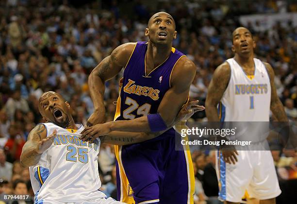 Kobe Bryant of the Los Angeles Lakers fouls Anthony Carter of the Denver Nuggets as he pushes him down in the second quarter in Game Three of the...