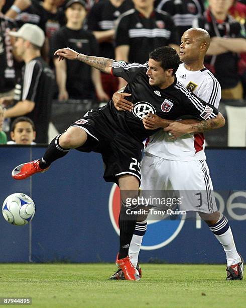 Santino Quaranta of D.C. United is held up by Robbie Russell of Real Salt Lake at RFK Stadium on May 23, 2009 in Washington, DC. The game ended in a...