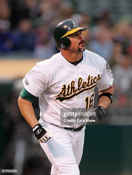 Jason Giambi of the Oakland Athletics watches his 400th career home run go over the outfield wall in the fourth inning of their game against the...