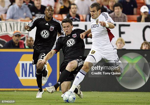 Marc Burch of D.C. United slides into Yura Movsisyan of Real Salt Lake at RFK Stadium on May 23, 2009 in Washington, DC. The game ended in a 0-0 tie.