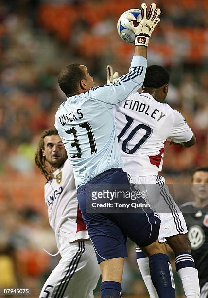 Josh Wicks of D.C. United plucks the ball from the head of Robbie Findley of Real Salt Lake at RFK Stadium on May 23, 2009 in Washington, DC. The...