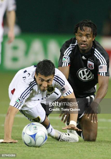 Luciano Emilio of D.C. United crawls after the ball behind Javier Morales of Real Salt Lake at RFK Stadium on May 23, 2009 in Washington, DC. The...