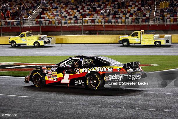 Mike Bliss, driver of the Miccosukee Indian Gaming & Resort Chevrolet, waits in his car on pit road in a rain delay during the NASCAR Nationwide...
