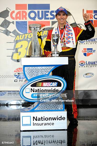 Mike Bliss, driver of the Miccosukee Indian Gaming & Resort Chevrolet, poses in victory lane after winning the NASCAR Nationwide Series CARQUEST Auto...