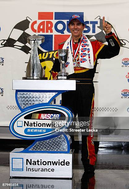 Mike Bliss, driver of the Miccosukee Indian Gaming & Resort Chevrolet, poses in victory lane after winning the NASCAR Nationwide Series CARQUEST Auto...