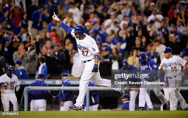 Matt Kemp of the Los Angeles Dodgers celebrates as he scores the winning run after a bases loaded walk to teammate Juan Pierre off of relief pitcher...