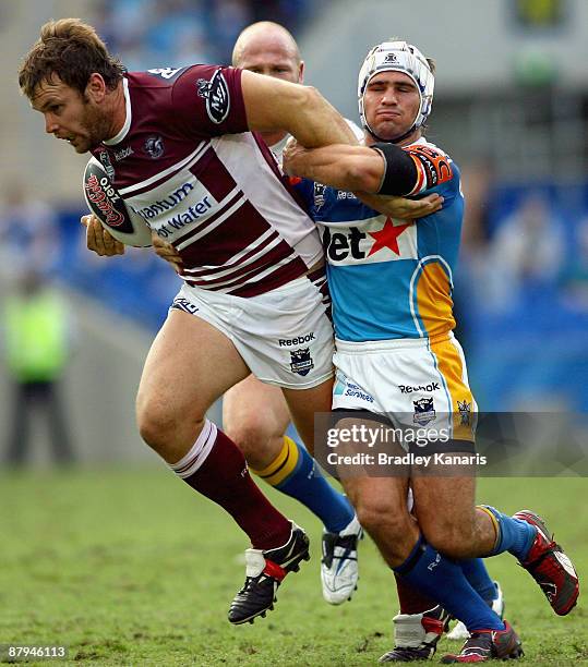 Josh Perry of the Sea Eagles takes on the Titans defence during the round 11 NRL match between the Gold Coast Titans and the Manly Warringah Sea...