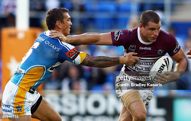 Anthony Watmough of the Sea Eagles fends away Mat Rogers of the Titans during the round 11 NRL match between the Gold Coast Titans and the Manly...