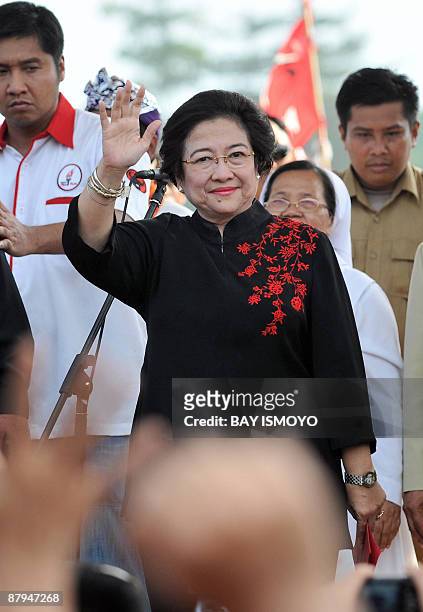 Former Indonesian president Megawati Sukarnoputri, the head of the Indonesia Democratic Party of Struggle, waves to her supporters during a...
