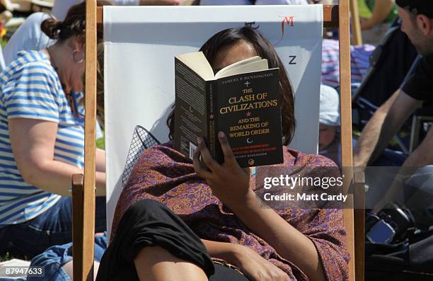 Festival-goer reads a book during the fourth day of the Guardian Hay Festival 2009 on May 24, 2009 in Hay-on-Wye, Wales. Sky Arts once again returns...